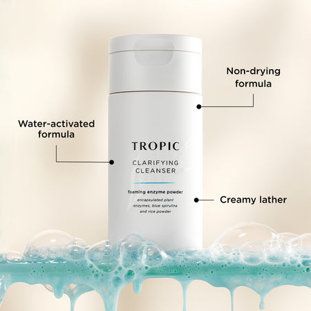 This image features Clarifying Cleanser, a foaming enzyme powder. Key features are annotated:
Water-activated formula, transforming into a creamy lather upon contact with water.
Non-drying formula to gently cleanse without stripping the skin.
Contains encapsulated plant enzymes, blue spirulina, and rice powder for a clarifying and nourishing cleanse.
The product is displayed with a fresh, foamy backdrop, emphasising its effective yet gentle cleansing action.